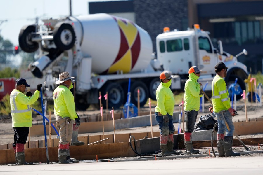 FILE - Construction crew members wait to pour concrete in a parking lot on Sept. 4, 2024, in Waukee, Iowa. (AP Photo/Charlie Neibergall, File)