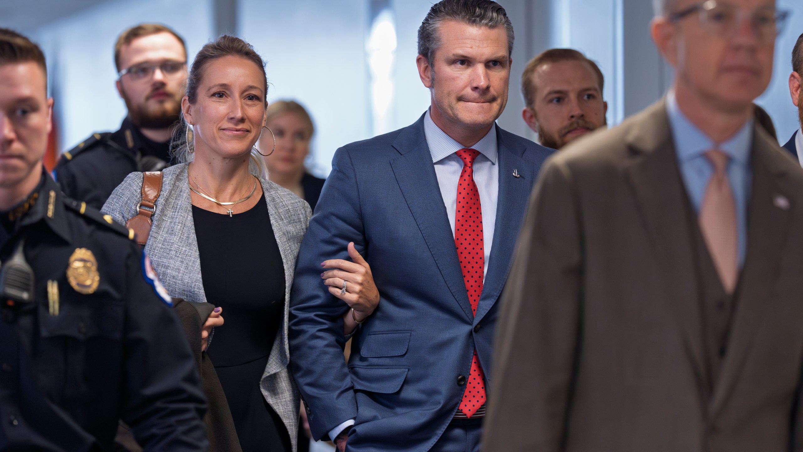 Pete Hegseth, center right, President-elect Donald Trump's nominee to be defense secretary, joined by his wife Jennifer Rauchet, arrives to meet with Sen. Mike Rounds, R-S.D., a member of the Senate Armed Services Committee, at the Capitol in Washington, Thursday, Dec. 5, 2024. (AP Photo/J. Scott Applewhite)
