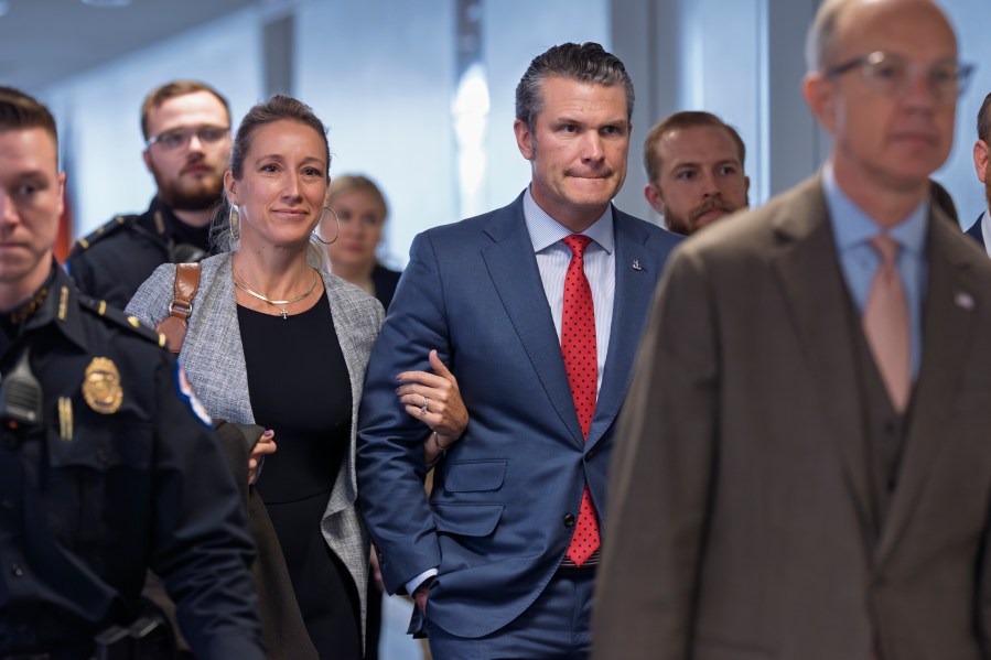 Pete Hegseth, center right, President-elect Donald Trump's nominee to be defense secretary, joined by his wife Jennifer Rauchet, arrives to meet with Sen. Mike Rounds, R-S.D., a member of the Senate Armed Services Committee, at the Capitol in Washington, Thursday, Dec. 5, 2024. (AP Photo/J. Scott Applewhite)