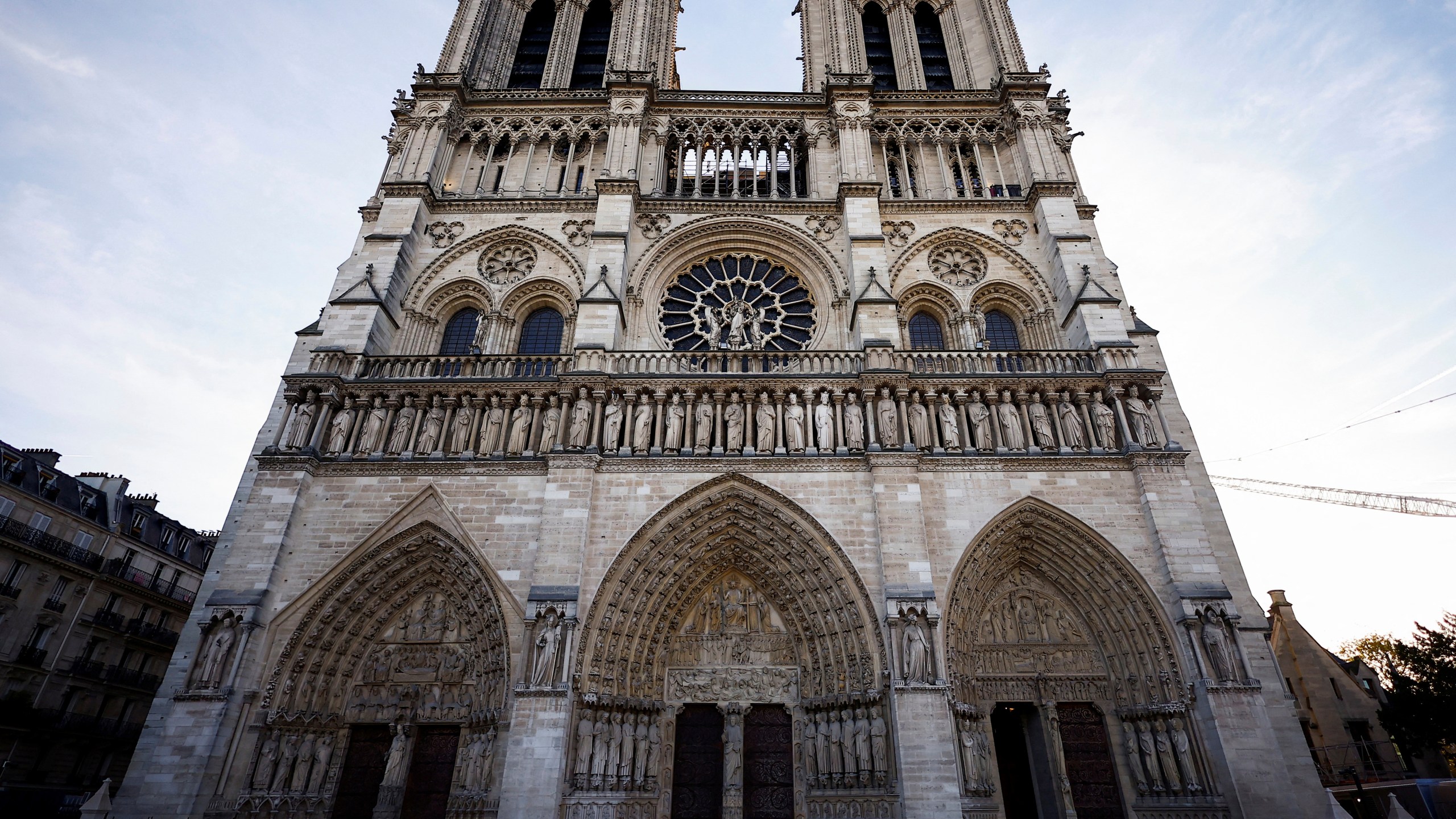 FILE - People stand outside Notre-Dame Cathedral in Paris, on Nov. 29 2024. (Sarah Meyssonnier/Pool Photo via AP, File)