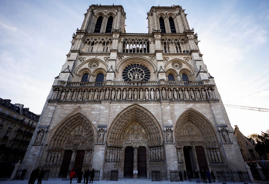 FILE - People stand outside Notre-Dame Cathedral in Paris, on Nov. 29 2024. (Sarah Meyssonnier/Pool Photo via AP, File)
