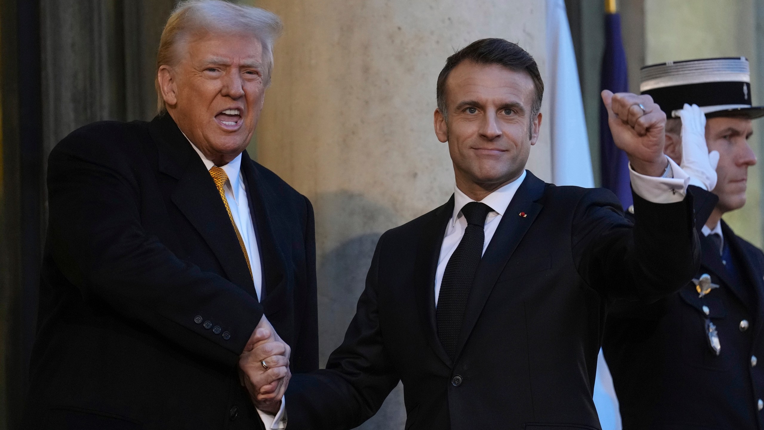French President Emmanuel Macron welcomes President-elect Donald Trump as he arrives at the Elysee Palace, Saturday, Dec. 7, 2024 in Paris. (AP Photo/Aurelien Morissard)