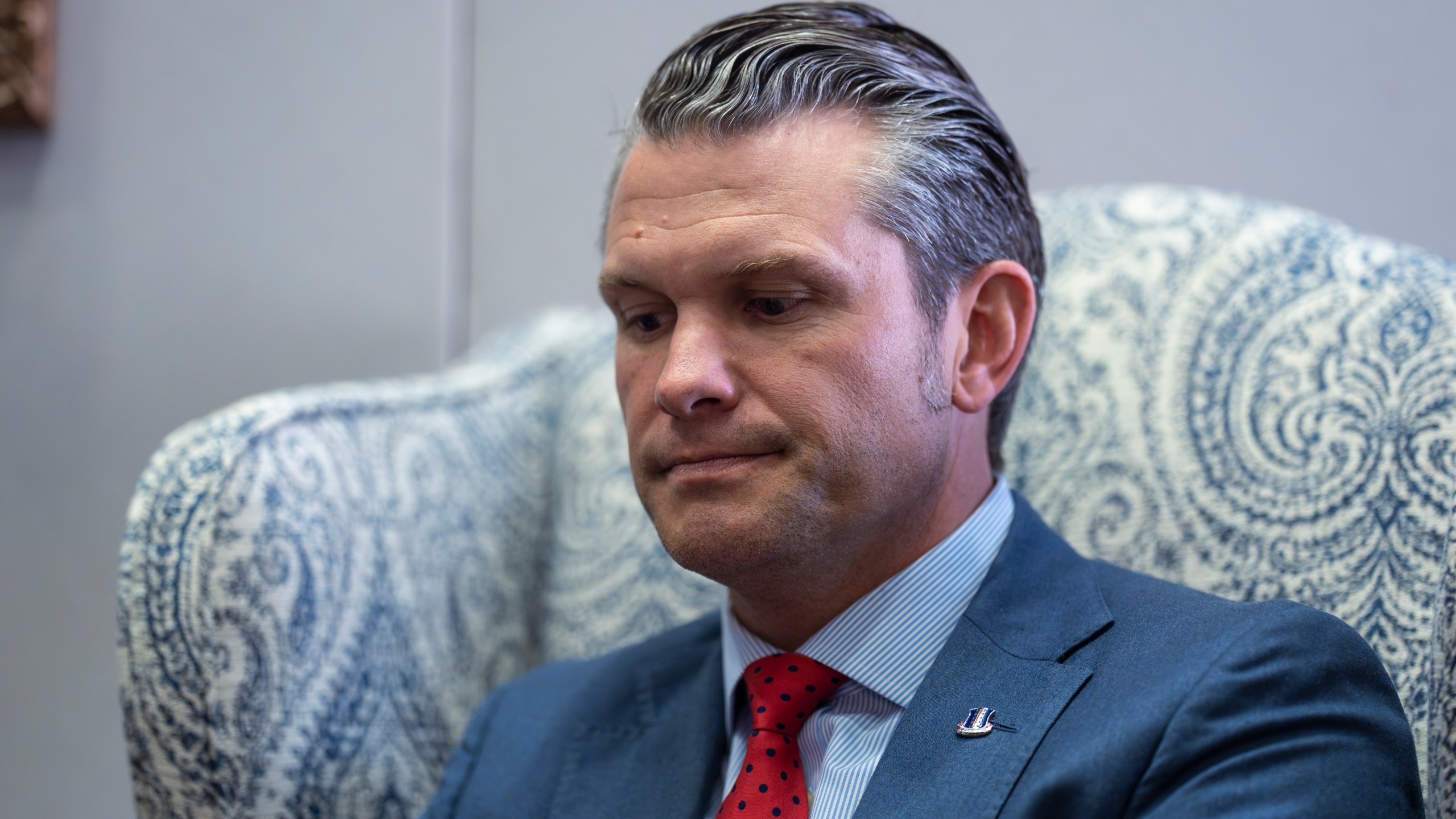 Pete Hegseth, President-elect Donald Trump's nominee to be defense secretary, listens to reporters during a meeting with Sen. Mike Rounds, R-S.D., a member of the Senate Armed Services Committee, at the Capitol in Washington, Thursday, Dec. 5, 2024. (AP Photo/J. Scott Applewhite)