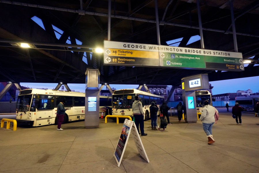 Commuters wait for buses at the George Washington Bridge Bus Station in New York, Friday, Dec. 6, 2024, where the gunman fleeing Wednesday's shooting of UnitedHealthcare CEO Brian Thompson took a taxi to, according to surveillance video. (AP Photo/Richard Drew)