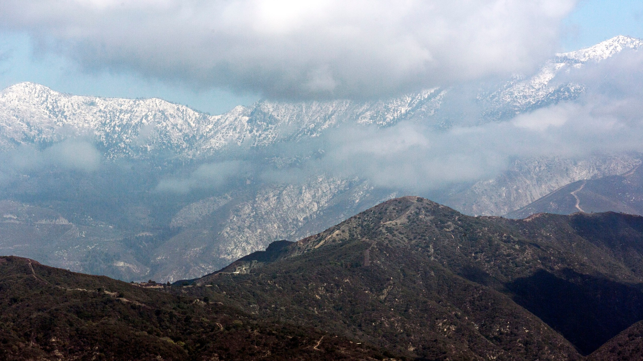 FILE - The San Gabriel Mountain range is covered in snow, Thursday Oct. 10, 2013, in Walnut, Calif. (AP Photo/Damian Dovarganes, File)