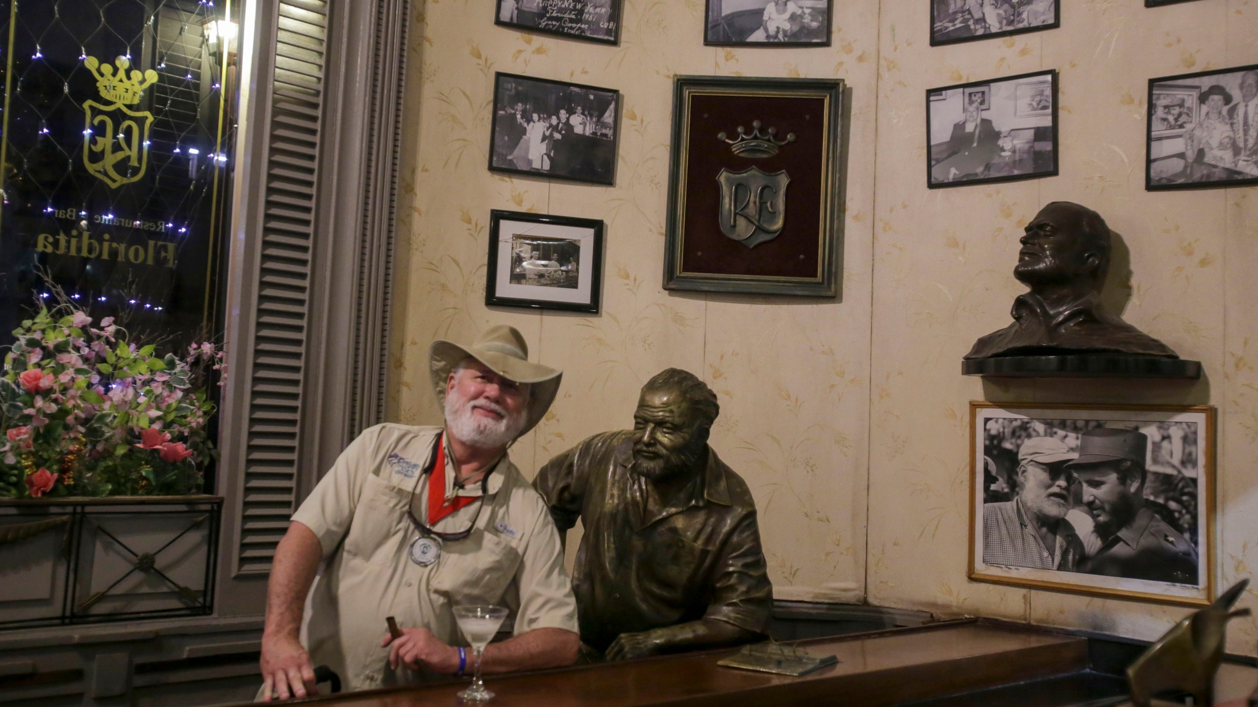 A man who pretends to look like the late American writer Ernest Hemingway poses for a photo recalling passages from the life and work of 1954 Nobel Prize-winning writer Ernest Hemingway at La Floridita bar in Havana, Cuba, Saturday, Dec, 6, 2024. (AP Photo/ Ariel Ley)