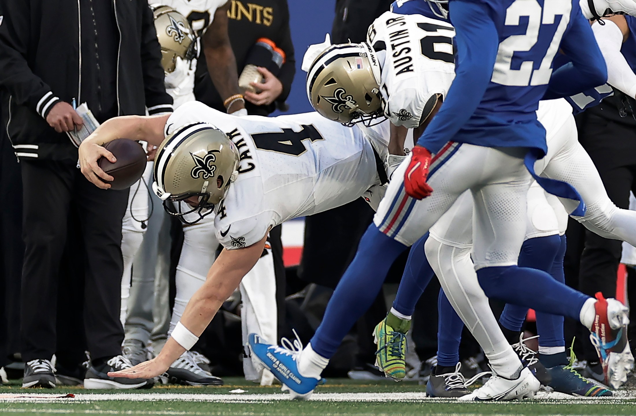 New Orleans Saints quarterback Derek Carr (4) comes down on his arm as he is tackled by the New York Giants during the fourth quarter of an NFL football game, Sunday, Dec. 8, 2024, in East Rutherford, N.J. (AP Photo/Adam Hunger)