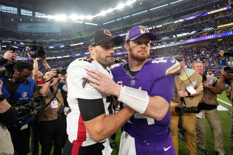 Atlanta Falcons quarterback Kirk Cousins, left, talks with Minnesota Vikings quarterback Sam Darnold after an NFL football game, Sunday, Dec. 8, 2024, in Minneapolis. (AP Photo/Abbie Parr)