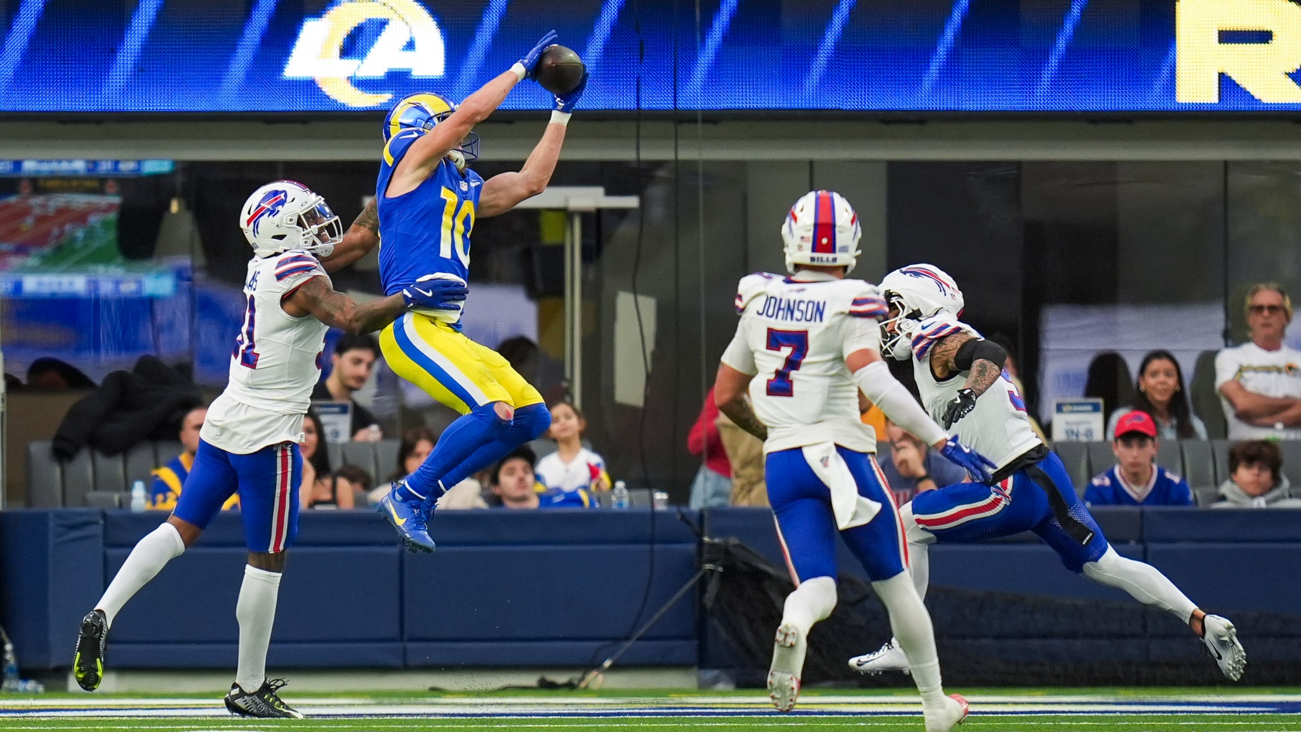 Los Angeles Rams wide receiver Cooper Kupp (10) scores a touchdown against Buffalo Bills cornerback Rasul Douglas, left, cornerback Taron Johnson (7) and safety Taylor Rapp (9) during the second half of an NFL football game, Sunday, Dec. 8, 2024, in Inglewood, Calif. (AP Photo/Gregory Bull)
