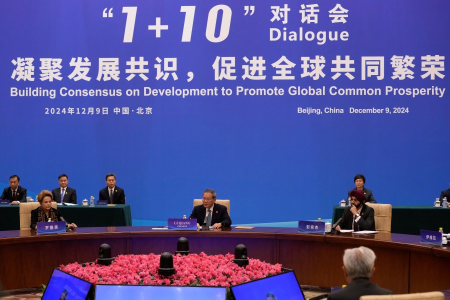Chinese Premier Li Qiang, center, speaks as he chairs the "1+10" Dialogue on Building Consensus on Development to Promote Global Common Prosperity, at the Diaoyutai State Guesthouse in Beijing, Monday, Dec. 9, 2024. (AP Photo/Andy Wong)
