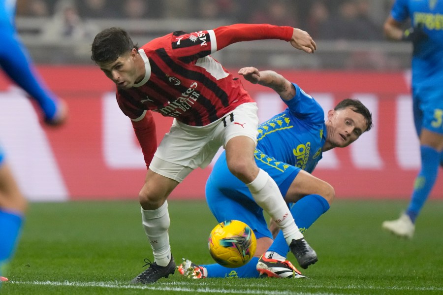 AC Milan's Christian Pulisic is challenged by Empoli's Liam Henderson, right, during the Italian Serie A soccer match between AC Milan and Empoli, at the Milan San Siro stadium, Italy, Saturday, Nov. 30, 2024. (AP Photo/Luca Bruno)