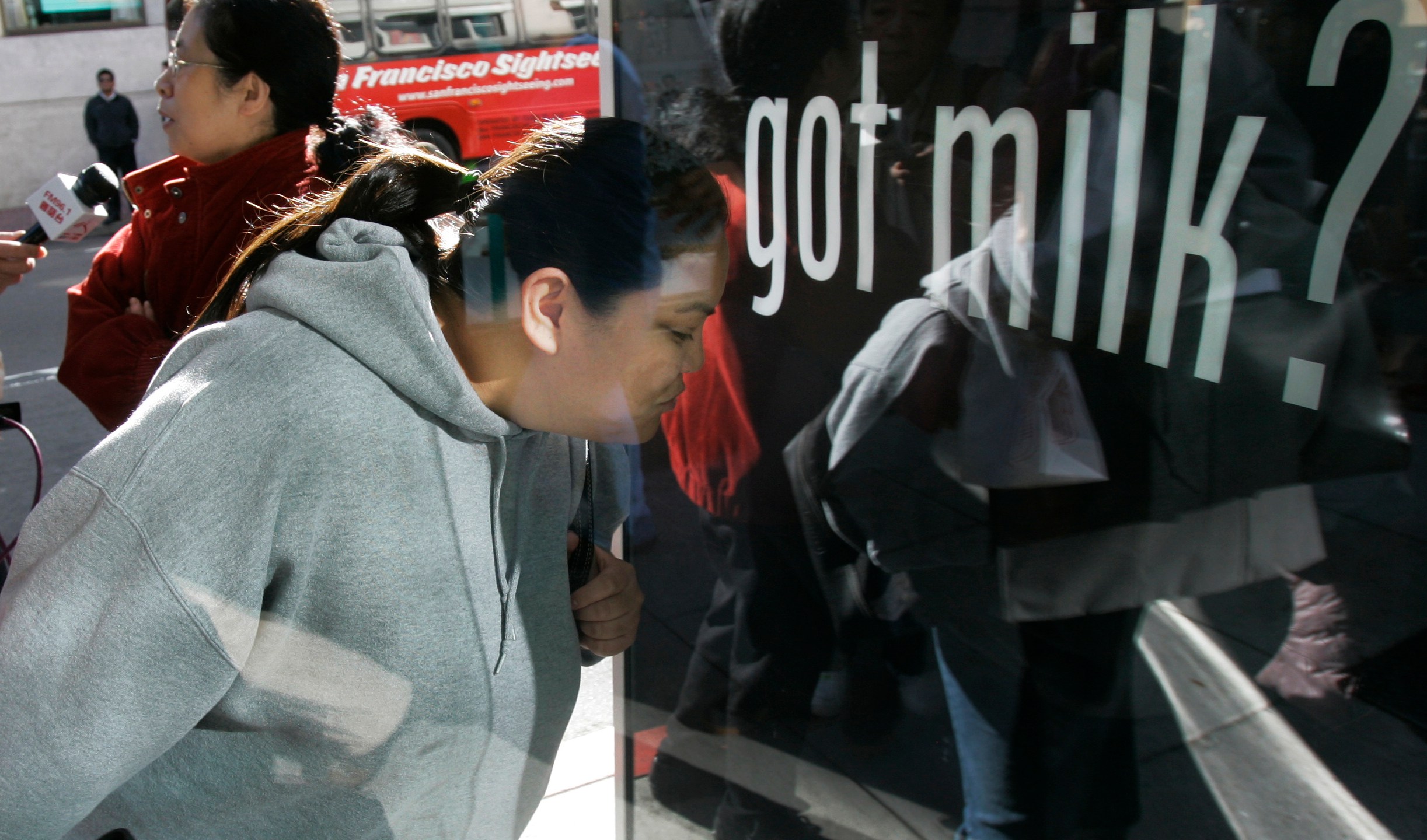 FILE - Ihrene Supapo smells the aroma around the new scented "Got Milk?" advertisement in San Francisco, Monday, Dec. 4, 2006. (AP Photo/Jeff Chiu, File)