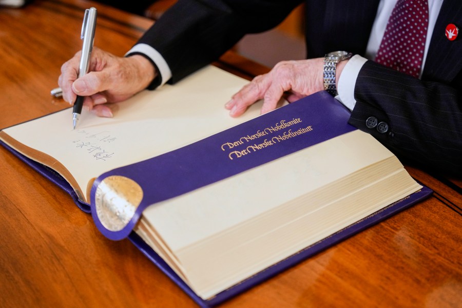 Representative of this year's Nobel Peace Prize winner Nihon Hidankyo, or the Japan Confederation of A- and H-Bomb Sufferers Organizations, Terumi Tanaka signs the guest book ahead of the Nobel Peace Prize ceremony, at the Nobel Institute in Oslo, on Monday, Dec. 9, 2024. (Javad Parsa/NTB Scanpix via AP)