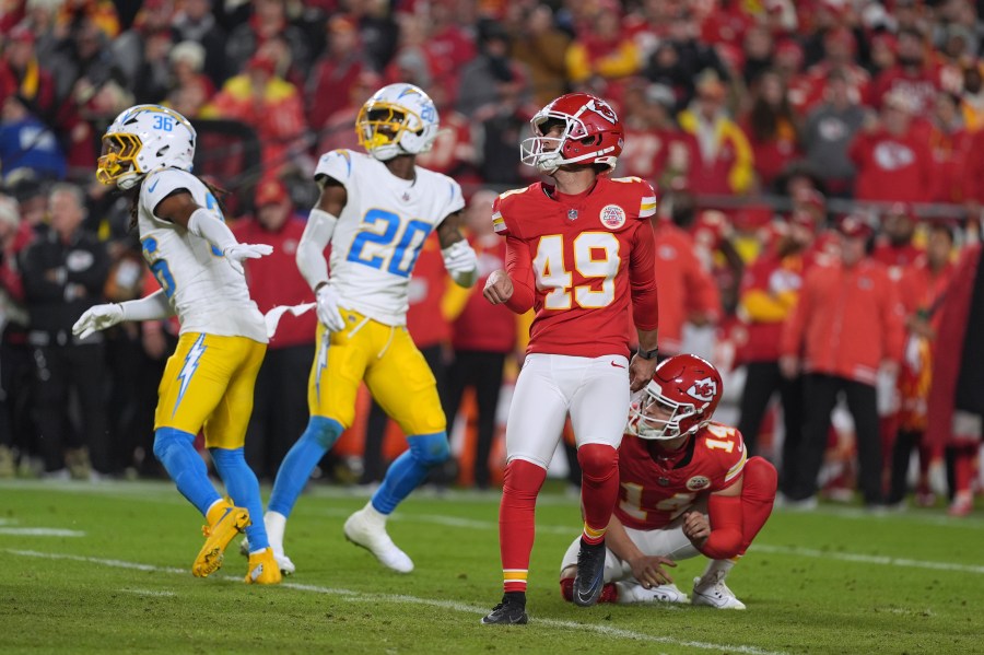 Kansas City Chiefs kicker Matthew Wright (49) watches his game-winning field goal as time expires in an NFL football game against the Los Angeles Chargers Sunday, Dec. 8, 2024, in Kansas City, Mo. (AP Photo/Charlie Riedel)
