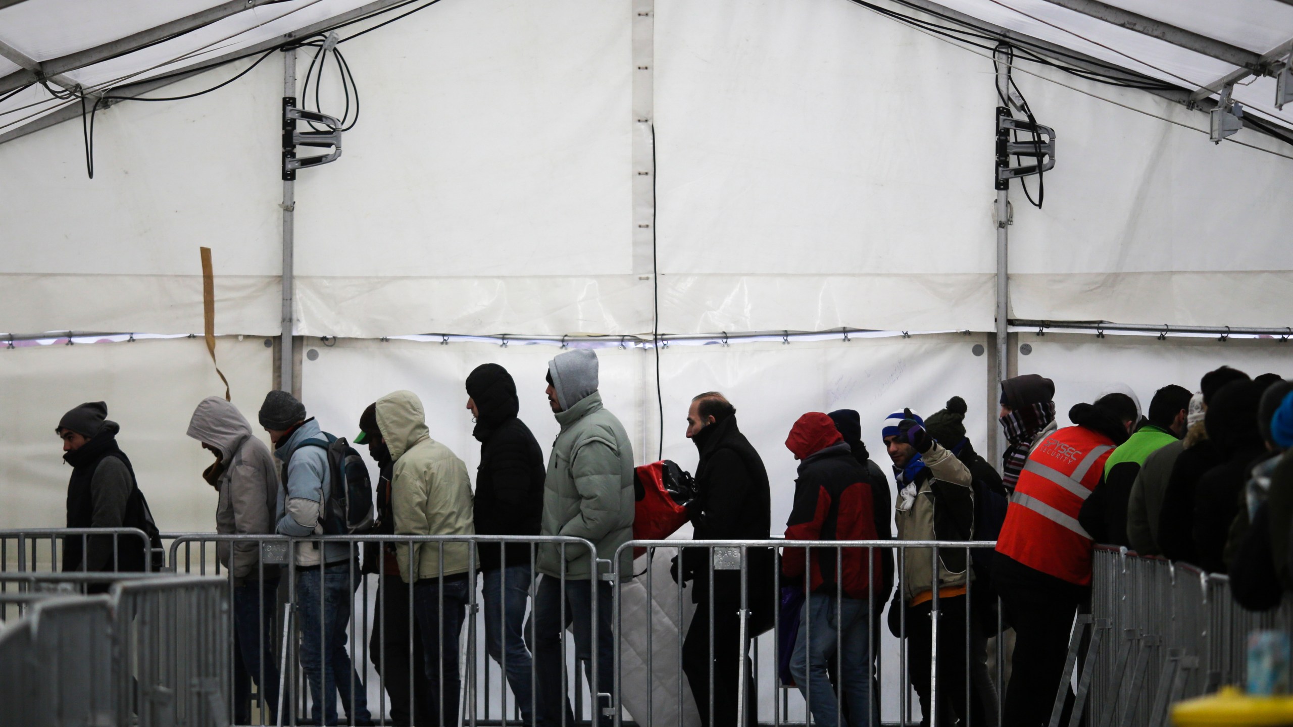FILE - Migrants and refugees line up at the central registration center for refugees and asylum seekers LaGeSo (Landesamt fuer Gesundheit und Soziales - State Office for Health and Social Affairs) LaGeSo in Berlin, Germany, Monday, Jan. 4, 2016. (AP Photo/Markus Schreiber, File)