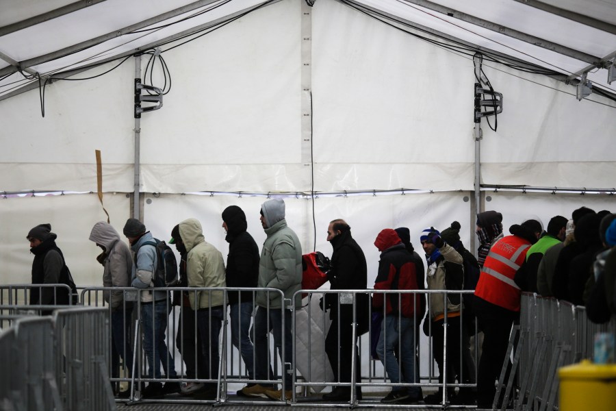 FILE - Migrants and refugees line up at the central registration center for refugees and asylum seekers LaGeSo (Landesamt fuer Gesundheit und Soziales - State Office for Health and Social Affairs) LaGeSo in Berlin, Germany, Monday, Jan. 4, 2016. (AP Photo/Markus Schreiber, File)