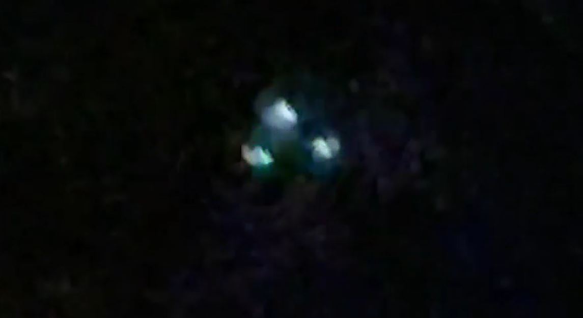 A picture of three lights in the sky in a triangular formation.