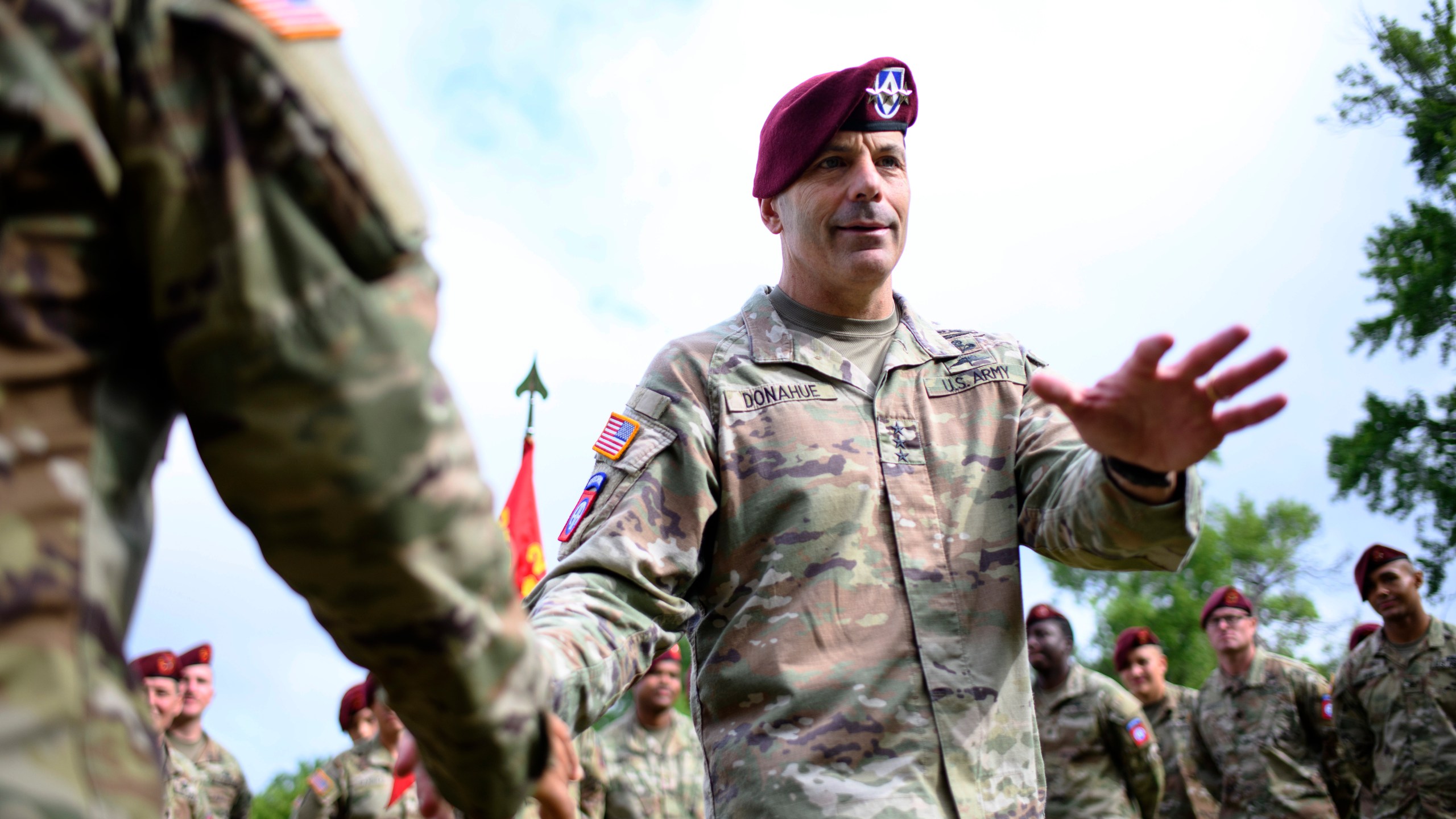 Lt. Gen. Christopher Donahue, 18th Airborne Corps commander, greets soldiers before a redesignation ceremony.