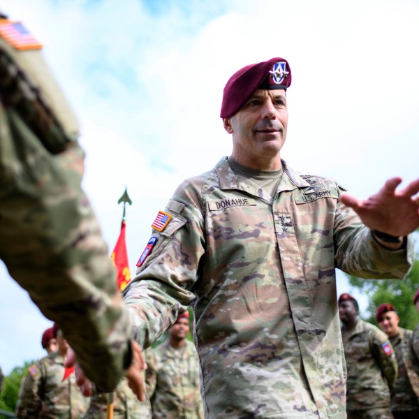 Lt. Gen. Christopher Donahue, 18th Airborne Corps commander, greets soldiers before a redesignation ceremony.