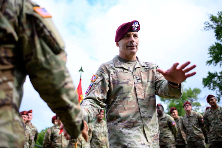 Lt. Gen. Christopher Donahue, 18th Airborne Corps commander, greets soldiers before a redesignation ceremony.