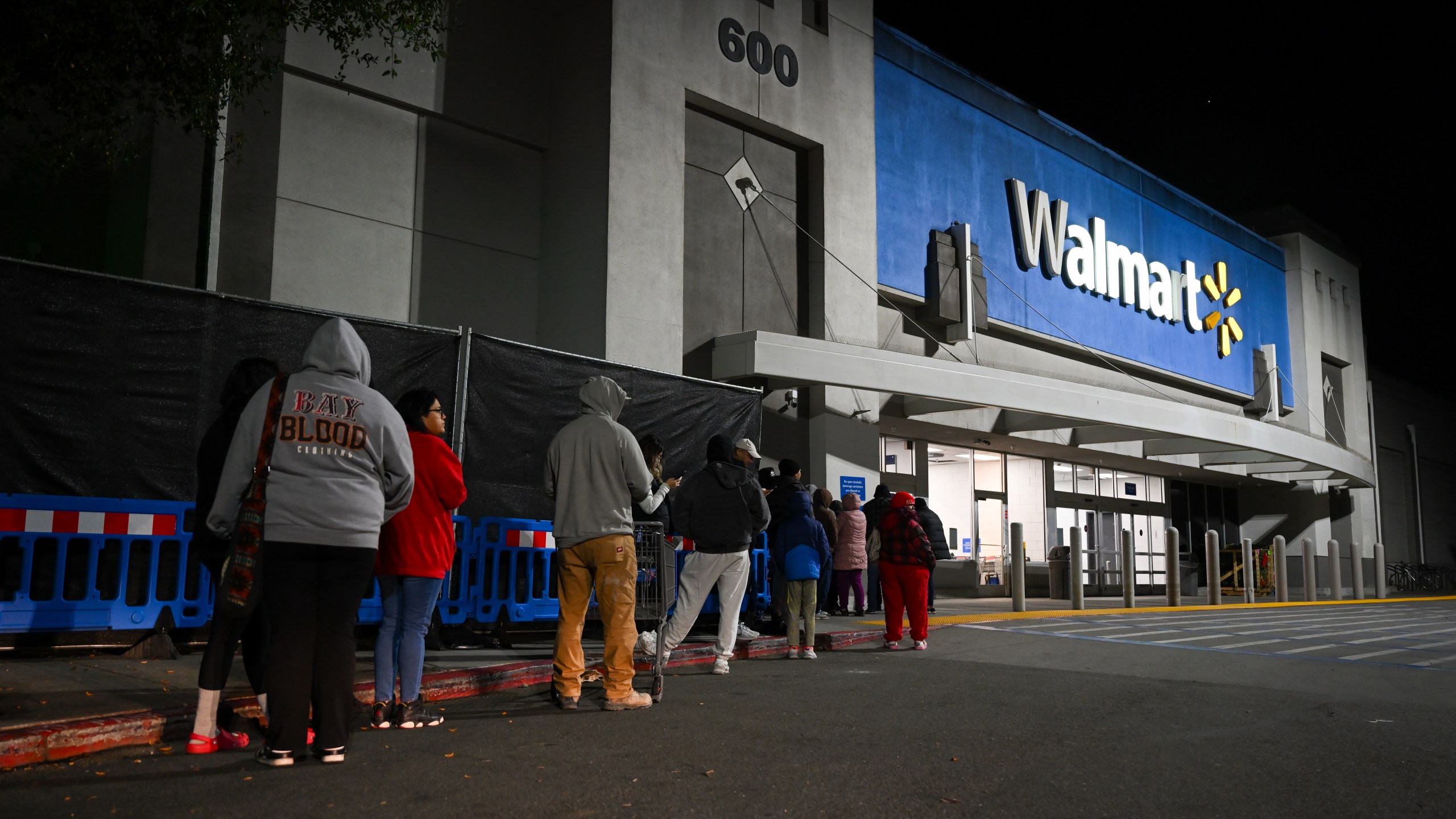 Shoppers wait in line outside a Walmart during the Friday shopping rush in Mountain View, California.