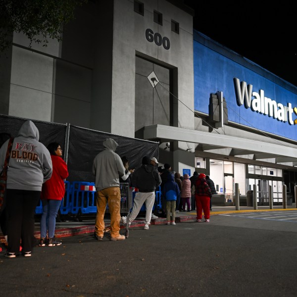 Shoppers wait in line outside a Walmart during the Friday shopping rush in Mountain View, California.