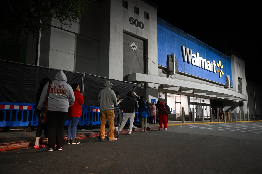 Shoppers wait in line outside a Walmart during the Friday shopping rush in Mountain View, California.